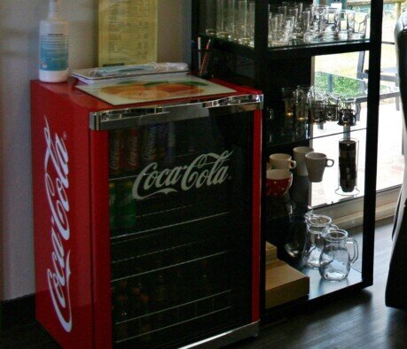 Fridge stocked with all kinds of soft drinks, juices, beers and local wine